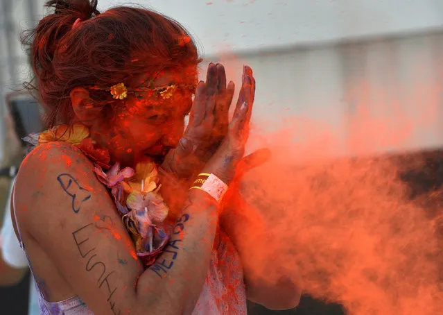 A reveller takes part in the Holi Party Festival at Niemeyer Center in Aviles, northern Spain, August 27, 2016. (Photo by Eloy Alonso/Reuters)