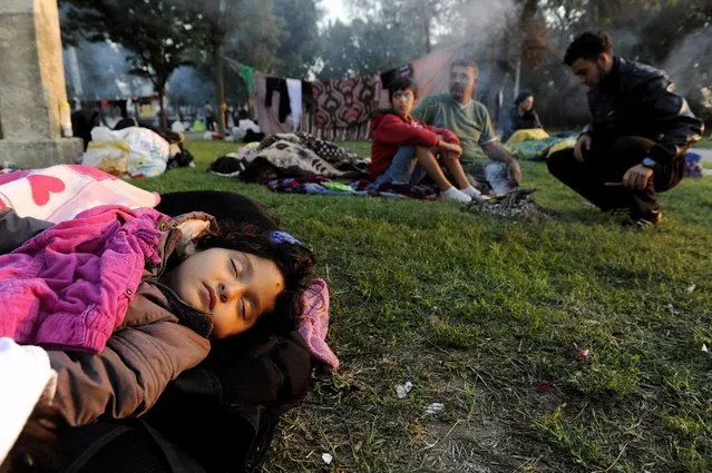 A migrant child sleeps at the surrounding area of the Sarayici oil wrestling arena in Edirne, Turkey, September 21, 2015. Bitterly-divided European leaders will seek to find a credible response to the continent's worst migration crisis since World War Two at an emergency summit this week. (Photo by Alexandros Avramidis/Reuters)