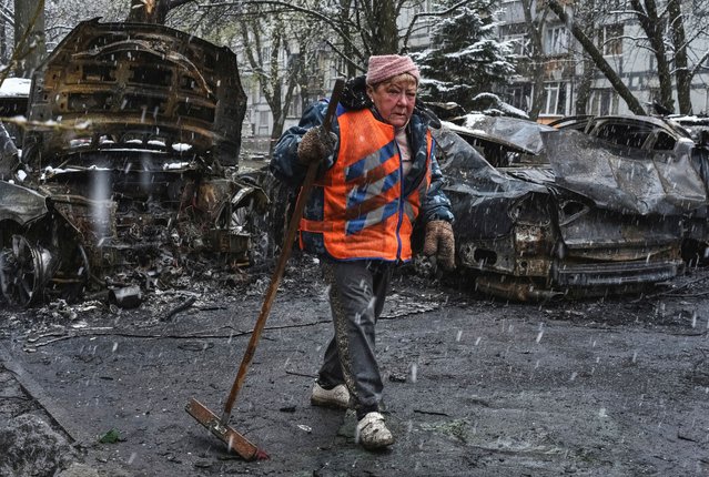 A municipal worker cleans an area at the site of Russian drone strike, amid Russia's attack on Ukraine, in Dnipro, Ukraine on April 9, 2025. (Photo by Mykola Synelnykov/Reuters)