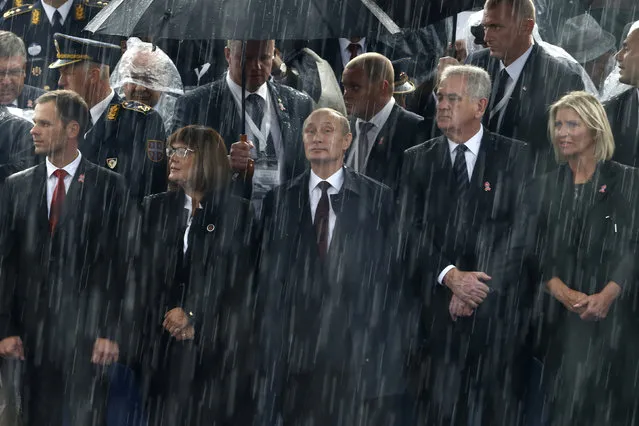 Russian President Vladimir Putin (C) and Serbian President Tomislav Nikolic (2nd R) attend a military parade to mark 70 years since the city's liberation by the Red Army in Belgrade October 16, 2014. (Photo by Marko Djurica/Reuters)