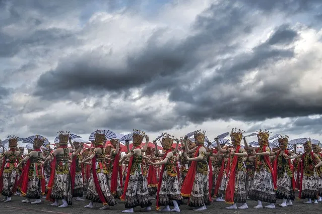 Traditional dancers perform during the annual Gandrung Sewu festival on Boom beach in Banyuwangi on October 29, 2022. (Photo by Juni Kriswanto/AFP Photo)