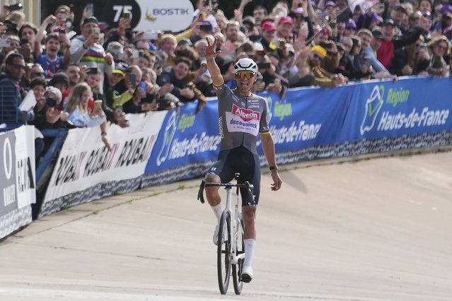 Mathieu van der Poel, of the Netherlands, gestures as he approaches the finish line to win the Paris-Roubaix cycling race for the third time in a row, in Roubaix, France, Sunday, April 13, 2025. (Photo by Thibault Camus/AP Photo)