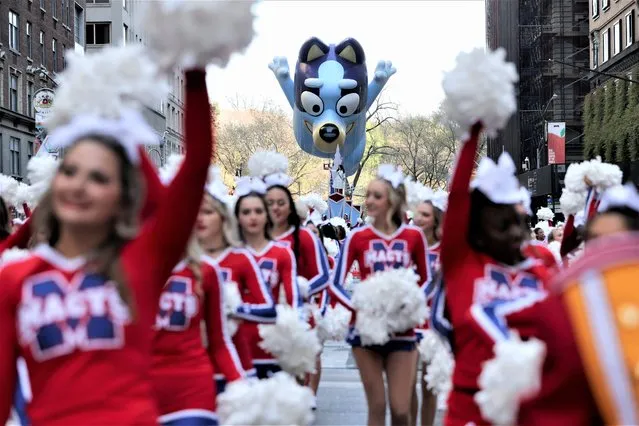 Bluey ballon flies as Spirit of America cheerleaders paricipate in the 96th Macy's Thanksgiving Day Parade in Manhattan, New York City, U.S., November 24, 2022. (Photo by Andrew Kelly/Reuters)