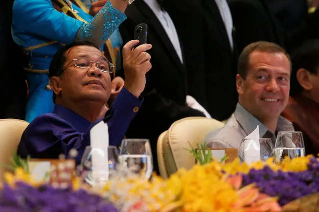 Cambodia's Prime Minister Hun Sen takes a picture of Russia's Prime Minister Dmitry Medvedev at the ASEAN Summit gala dinner in Vientiane, Laos September 7, 2016. (Photo by Jonathan Ernst/Reuters)