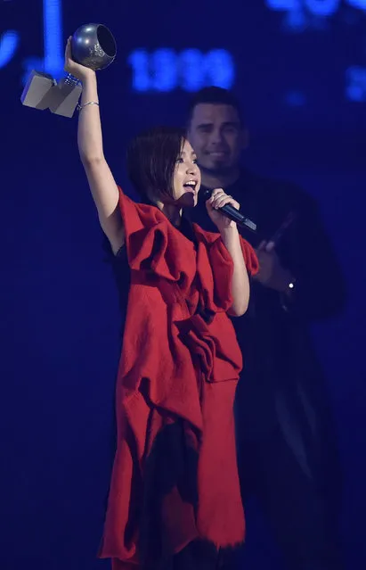 Singer BiBi Zhou reacts on stage after receiving her award during the 2014 MTV Europe Music Awards at the SSE Hydro Arena in Glasgow. (Photo by Toby Melville/Reuters)