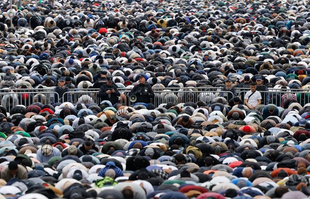 Law enforcement officers stand guard as muslims attend Eid al-Adha mass prayer, marking the end of the hajj pilgrimage near Moscow's grand mosque in Russia, on June 6, 2025. (Photo by Maxim Shemetov/Reuters)