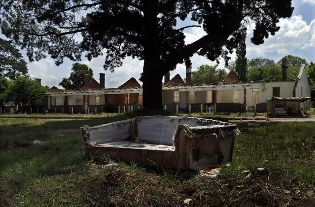 This October 24, 2014, photo shows a broken coach placed next a road nearby abandoned houses at Durban Deep mine residential area in Roodepoort, west of Johannesburg, South Africa. The once sought-after mining facility at Durban Deep now is in a crime-ridden state. The buildings have been stripped of everything valuable and sold for cash. (Photo by Themba Hadebe/AP Photo)