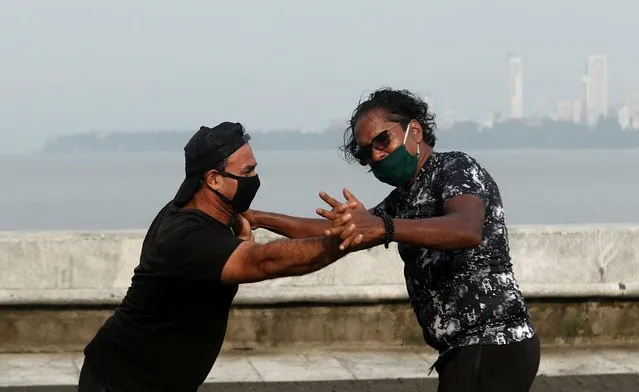 People wearing protective masks exercise at a promenade amidst the spread of the coronavirus disease (COVID-19) in Mumbai, India, September 9, 2020. (Photo by Francis Mascarenhas/Reuters)