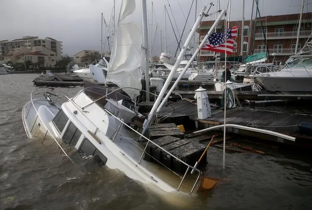 An U.S. flag flies from a boat damaged by Hurricane Sally in Pensacola, Florida, U.S., September 16, 2020. (Photo by Jonathan Bachman/Reuters)