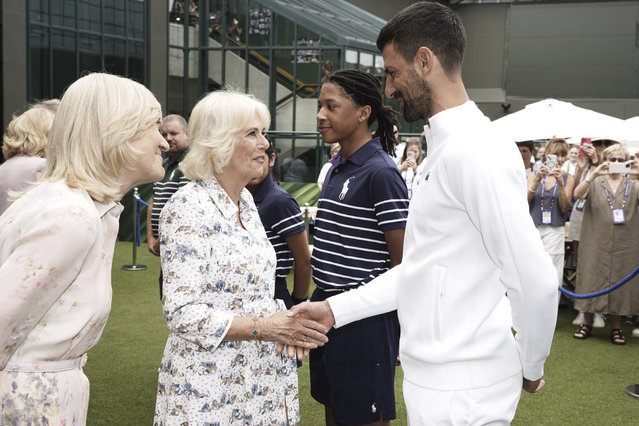 Britain's Queen Camilla, left, Charles, shakes hands with Novak Djokovic at the All England Lawn Tennis and Croquet Club on day ten of the 2025 Wimbledon Championships, Wednesday July 9, 2025. (Photo by Jordan Pettitt/PA Wire via AP Photo)