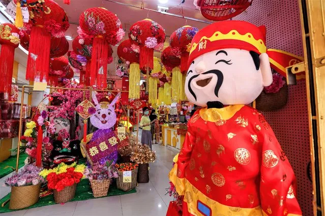 People shop for Lunar New Year decorations at Petaling Street, Chinatown on January 15, 2023 in Kuala Lumpur, Malaysia. (Photo by Annice Lyn/Getty Images)