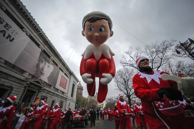The Elf on the Shelf balloon floats down Central Park West during the 88th Macy's Thanksgiving Day Parade in New York November 27, 2014. (Photo by Eduardo Munoz/Reuters)