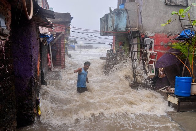 A man watches waves caused by high tide hit his house on the shore of the Arabian Sea in Mumbai, India, Wednesday, June 25, 2025. (Photo by Rafiq Maqbool/AP Photo)