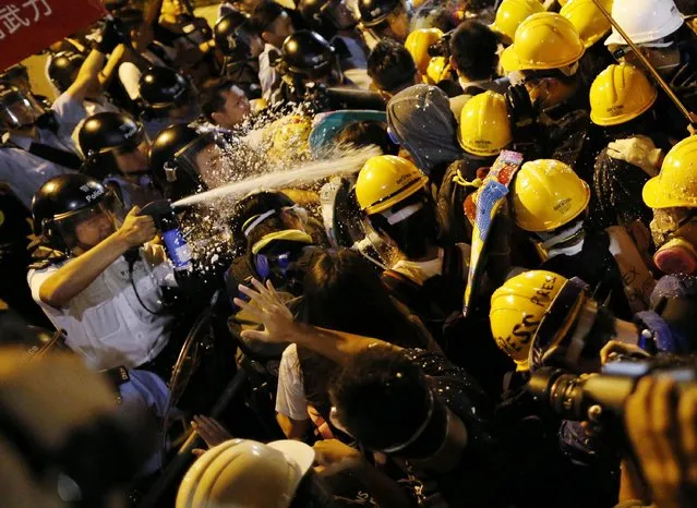 Police use pepper spray during clashes with pro-democracy protesters close to the chief executive office in Hong Kong, November 30, 2014. (Photo by Tyrone Siu/Reuters)