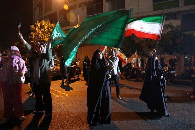 A group of Iranians celebrate following Iran's attack on U.S. military base in Qatar, in Tehran, Iran on June 23, 2025. (Photo by Majid Asgaripour/WANA via Reuters)