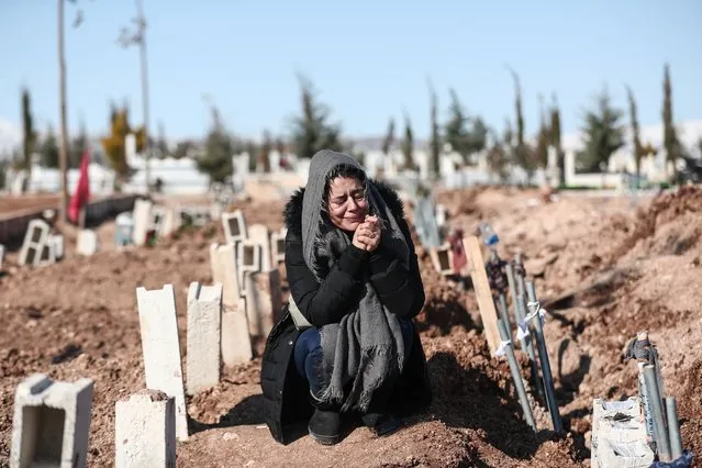 A woman mourns her relatives at a mass grave area following a major earthquake in Adiyaman, southeastern Turkey, 11 February 2023. More than 24,000 people have died and thousands more are injured after two major earthquakes struck southern Turkey and northern Syria on 06 February. Authorities fear the death toll will keep climbing as rescuers look for survivors across the region. (Photo by Sedat Suna/EPA/EFE/Rex Features/Shutterstock)