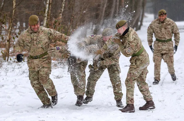 Members of 1st Battalion Welsh Guards take part in a snow ball fight before the combined St David's Day celebration and pre-deployment service at Elizabeth Barracks, Pirbright, Surrey on March 01, 2018. (Photo by Andrew Matthews/PA Images via Getty Images)