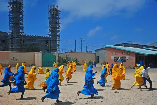 Somali school girls play football during lunch break at the Howlwadag Primary School in Howlwadag District, south of Mogadishu, on October, 5, 2016. (Photo by Mohamed Abdiwahab//AFP Photo)