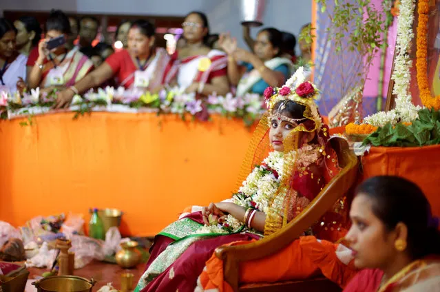 An Indian girl Ishani Chatterjee (R) dressed as Goddess Durga is worshipped during the Durga Puja festival at Shidaspur village north of Calcutta Eastern India on 10 October 2016. The “Kanya” or Kumari Puja is a ritual of worshipping a girl aged between six and twelve years, symbolizing the Kanya Kumari (virgin) form of the Goddess Durga Devi. Hindu devotees perform the Kanya Puja in front of an idol of the Goddess Durga and believe that a Kanya is a living impersonation of the goddess. (Photo by Piyal Adhikary/EPA)