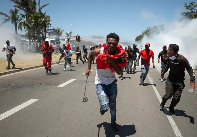 People run away from teargas during the opposition Economic Freedom Fighters party's protest against alleged racism outside Brackenfell High School in Cape Town, South Africa, November 20, 2020. (Photo by Mike Hutchings/Reuters)