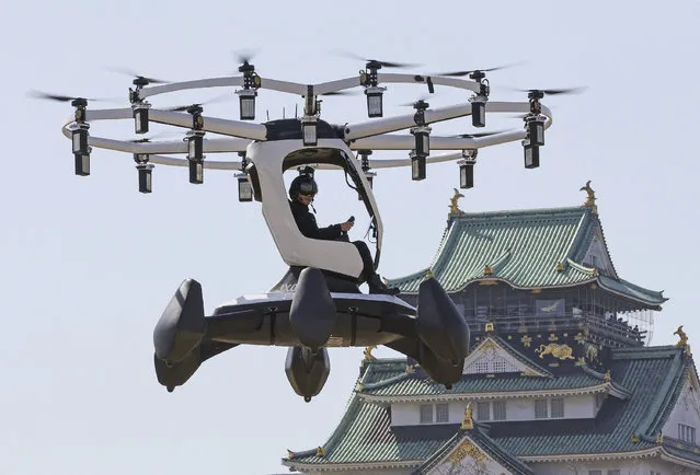 A pilot demonstrates an aircraft manufactured by US-based LIFT Aircraft in front of Osaka Castle in Osaka on March 14, 2023. (Photo by JIJI Press/AFP Phoot)