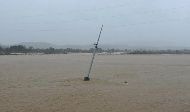 A utility pole is partially submerged in a river after Typhoon Haima struck San Nicolas, Ilocos Norte in northern Philippines, October 20, 2016. (Photo by Ezra Acayan/Reuters)