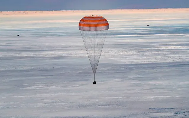 The Soyuz MS-13 capsule carrying the International Space Station (ISS) crew of NASA astronaut Christina Koch, Russian cosmonaut Alexander Skvortsov and Luca Parmitano of the European Space Agency, descends beneath a parachute before landing in a remote area outside the town of Dzhezkazgan (Zhezkazgan), Kazakhstan, on February 6, 2020. (Photo by Sergei Ilnitsky/Pool via AFP Photo)
