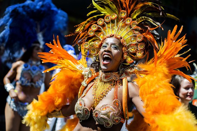 A dancer representing Brazil performs during the Carnival Of Cultures parade in Berlin, on May 19, 2013. Some 75 groups representing different countries from all over the world take part in the annual parade, and tens of thousands of spectators gather along the streets. (Photo by Gero Breloer/Associated Press)