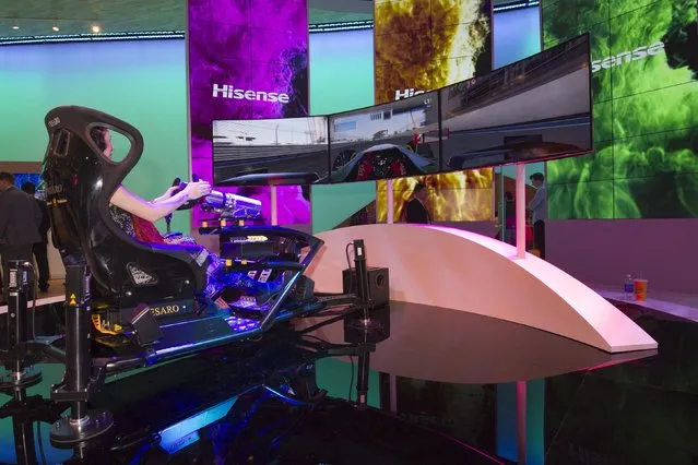 Alex Eisch, an engineer with Yottaworks, tries out a driving simulator at the Hisense booth during the 2015 International Consumer Electronics Show (CES) in Las Vegas, Nevada January 6, 2015. (Photo by Steve Marcus/Reuters)