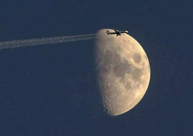A passenger jet flies past the waxing moon over Zurich in this June 30, 2009 file photo. Citing "increased terrorist threats" from militant groups in various regions of the world, the U.S. State Department issued a global alert on November 23, 2015 for Americans planning to travel following deadly militant attacks in France and Mali. (Photo by Arnd Wiegmann/Reuters)