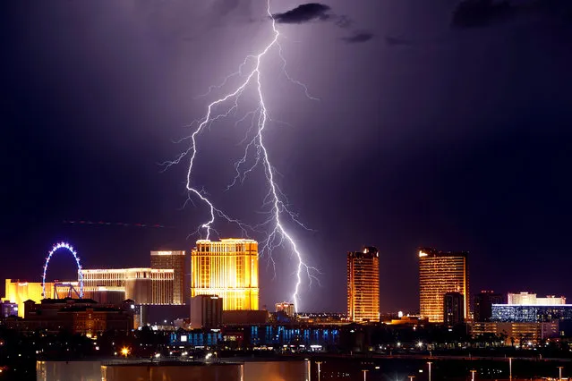 Lightning strikes behind Las Vegas Strip casinos as a thunderstorm passes through Las Vegas, Nevada, U.S. September 13, 2017. (Photo by Steve Marcus/Reuters)
