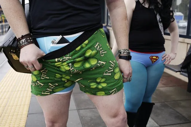 A participant shows off his underwear flask pocket during the annual No Pants Light Rail Ride organized by the Emerald City Improv group in Seattle, Washington January 11, 2015. (Photo by Jason Redmond/Reuters)