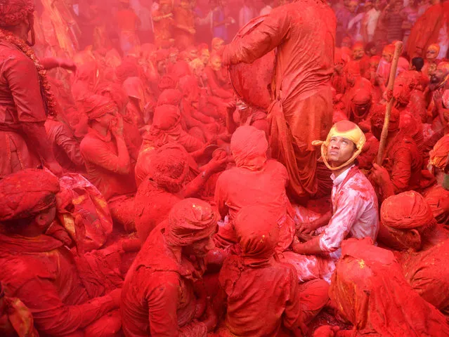 “Surrendering to Holi –The Festival of Colour”. The Holi celebration by the villagers of varsana village in Uttar Pradesh, India is literally a riot of colour. The inhabitants of Varsana village shower hundreds of buckets of liquid colours to drench the visiting members of the neighbouring village, followed by huge sacks of powdered colour to stick to their wet bodies. While battling my camera through the colour filled air I spotted this young villager with an expression of anticipation and surrender on his face as he anxiously awaited the next colour blast. (Photo and caption by Tanmoy Das/National Geographic Traveler Photo Contest)