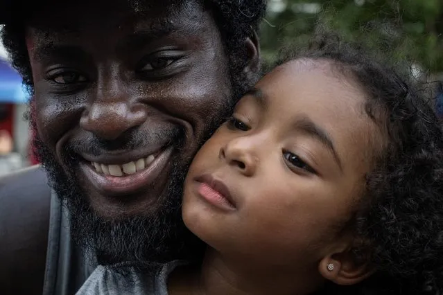 Kyle Bowman holds his three year old daughter Mila on Father's Day during Juneteenth celebrations at Discovery Green in Houston, Texas, U.S., June 18, 2023. (Photo by Adrees Latif/Reuters)