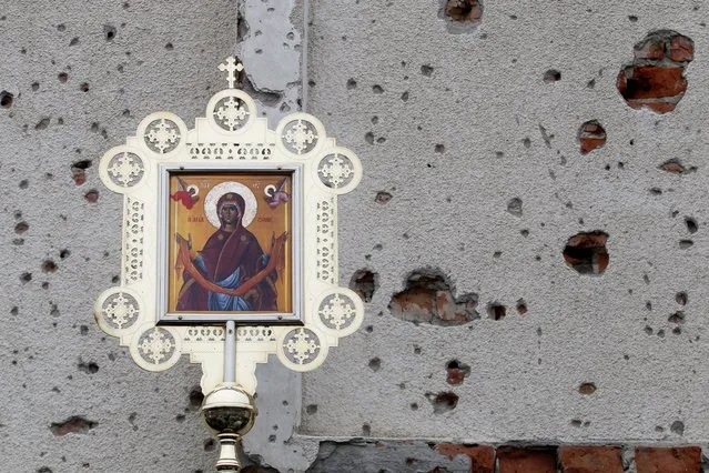 A view shows an icon during a service outside the Iversky monastery, which was heavily damaged by artillery and gun fire in the course of a battle for a local airport between the armed forces of Ukraine and the separatist self-proclaimed Donetsk People's Republic, in Donetsk, Ukraine, February 25, 2021. (Photo by Alexander Ermochenko/Reuters)