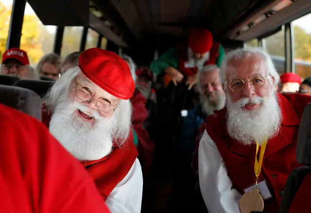 Santas board a bus for a field trip from the Charles W. Howard Santa Claus School in Midland, Michigan, U.S. October 28, 2016. (Photo by Christinne Muschi/Reuters)