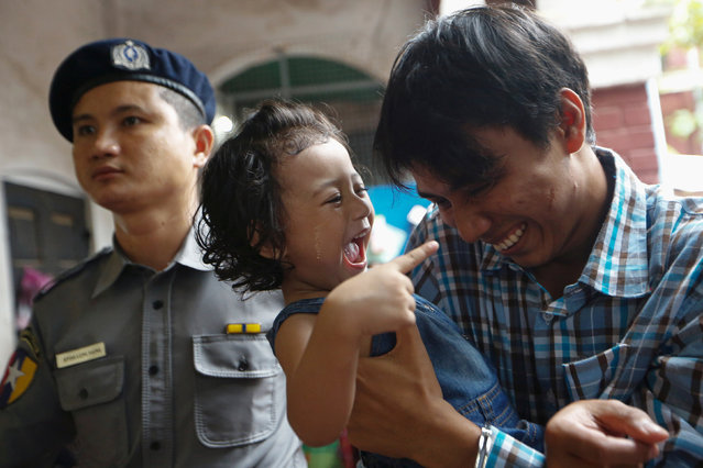 Detained Reuters journalist Kyaw Soe Oo plays with his daughter as he is escorted by police at Insein court in Yangon, Myanmar July 24, 2018. (Photo by Ann Wang/Reuters)