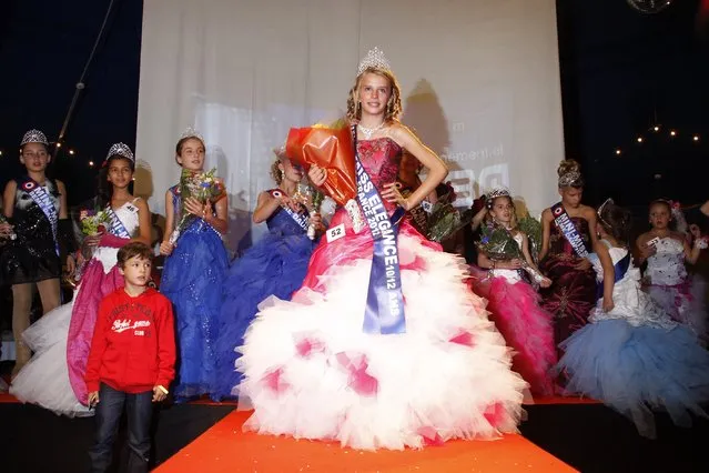 The winners celebrate on stage during the “mini-miss” beauty contest in Bobigny, Paris suburb, September 22, 2012. The competition is open for girls aged 7 to 12. (Photo by Benoit Tessier/Reuters)