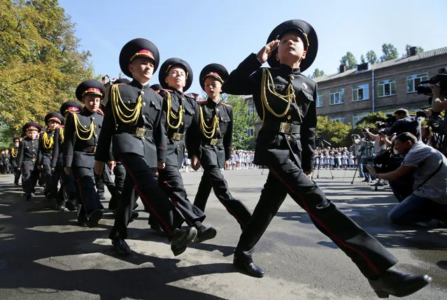 Ukrainian cadets from cadet's lyceum march in a school yard during the first day of school, which marks the traditional start of the academic year in Kiev, Ukraine, 01 September 2014. Russian President Vladimir Putin on 31 August 2014 called for talks between the Ukrainian government and separatist militants fighting in the east of the country, including on the issue of statehood. (Photo by Tatyana Zenkovich/EPA/EFE)
