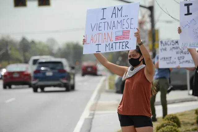Jennifer Nguyen holds a sign up in view of passing traffic, as she attends a rally on a national day of action to combat anti-Asian violence in Chamblee, Georgia, U.S., March 27, 2021. (Photo by Bita Honarvar/Reuters)