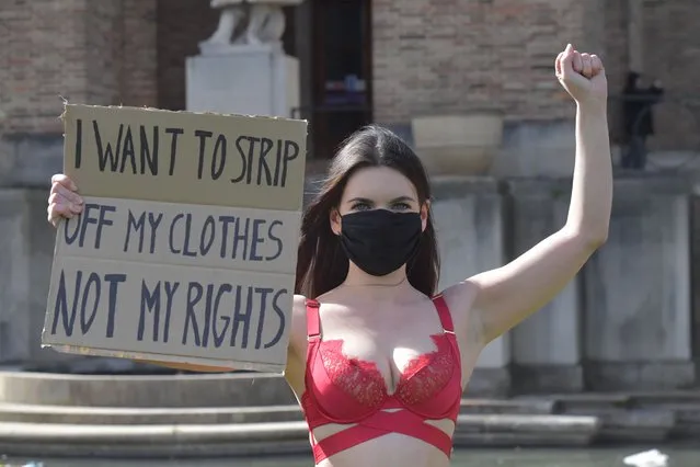 Strippers stage a protest over a city’s plan to become the latest in England to ban lap dancing clubs on College Green in Bristol, United Kingdom on April 6, 2021. Performers paraded in lingerie and held up placards. (Photo by South West News Service)