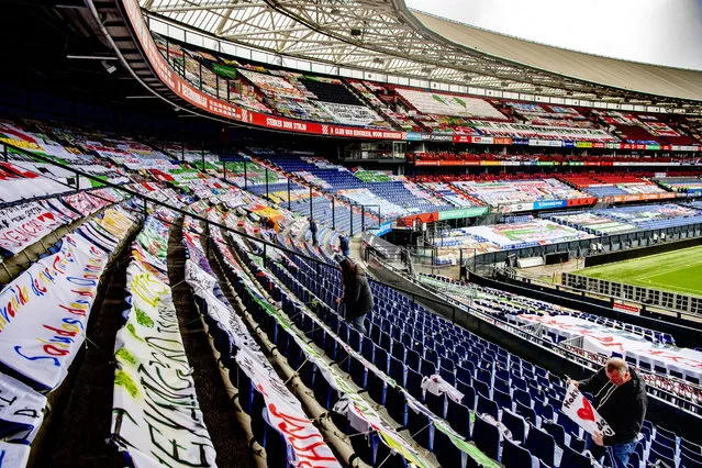 Thousands of Feyenoord fans' banners are removed from De Kuip stadium in Rotterdam, on April 6, 2021, ahead of the cup final football match between Ajax Amsterdam and Vitesse Arnhem. (Photo by Robin Utrecht/AFP Photo)