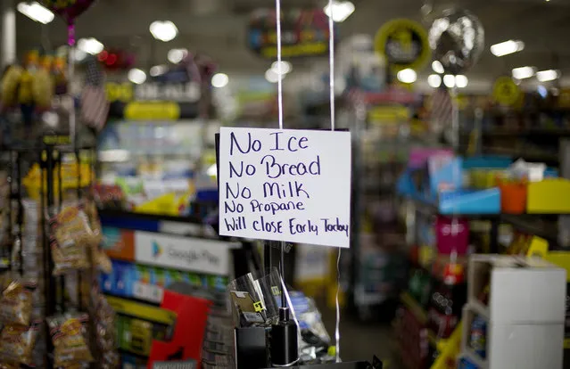 A message greets shoppers of supplies no longer available as Hurricane Florence approaches the east coast in Nichols, S.C., Thursday, September 13, 2018. The residents of this tiny inland town who rebuilt after Hurricane Matthew destroyed 90 percent of the homes are uneasy as forecasters warn inland flooding from Florence's rain could be one of the most dangerous and devastating parts of the storm. (Photo by David Goldman/AP Photo)