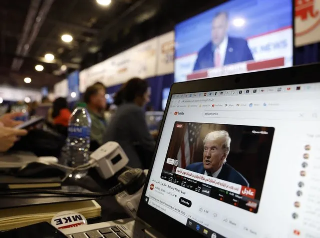 A reporter watches former President Donald Trump's online interview with Tucker Carlson at the media filing center during the first Republican candidates' debate of the 2024 U.S. presidential campaign in Milwaukee, Wisconsin, U.S. August 23, 2023. (Photo by Jonathan Ernst/Reuters)