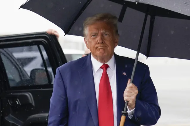 Former President Donald Trump walks over to speak with reporters before he boards his plane at Ronald Reagan Washington National Airport, Thursday, August 3, 2023, in Arlington, Va., after facing a judge on federal conspiracy charges that allege he conspired to subvert the 2020 election. (Photo by Alex Brandon/AP Photo)