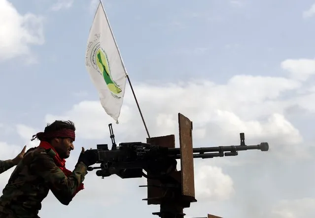 A Shi'ite fighter mans a weapon during clashes with Islamic State militants in Salahuddin province March 2, 2015. Iraq's armed forces, backed by Shi'ite militia, attacked Islamic State strongholds north of Baghdad on Monday as they launched an offensive to retake the city of Tikrit and the surrounding Sunni Muslim province of Salahuddin. REUTERS/Thaier Al-Sudani 