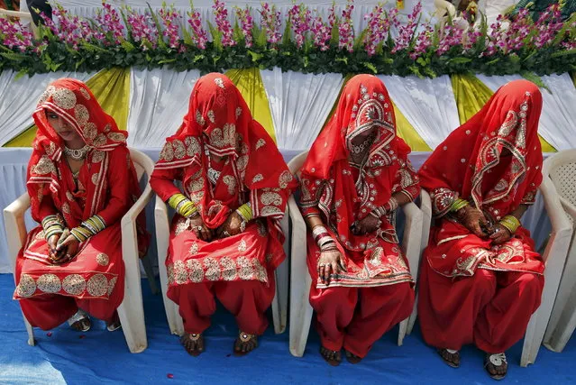 Muslim brides sit as they wait for the start of a mass marriage ceremony in Ahmedabad March 21, 2015. (Photo by Amit Dave/Reuters)