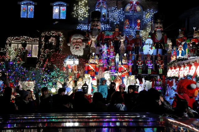 People walk by at the Dyker Heights Christmas Lights in the Dyker Heights neighborhood of Brooklyn, New York City, U.S., December 23, 2016. (Photo by Andrew Kelly/Reuters)