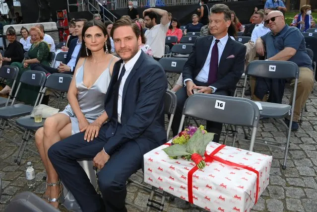 Spanish-German actor and director Daniel Bruhl and his wife Felicitas Rombold sit during the screening of the film “Nebenan” (Next Door) at the Berlinale Summer Special film festival in Berlin, Germany on June 16, 2021. (Photo by Jens Kalaene/Pool via Reuters)