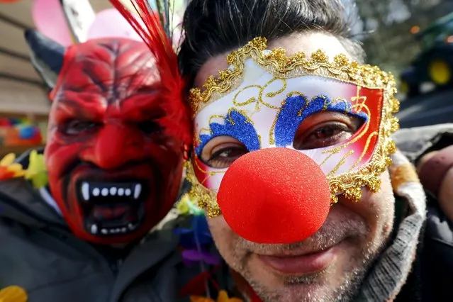 Ali (R) and Hatep (L), refugees from the Syrian capital of Damascus, pose before taking part in a carnival parade in Mettmann, Germany February 6, 2016. Three refugees from Syria and one from Iraq took part in the parade in the town of Mettmann, near Duesseldorf on Saturday. The motto of the city's carnival parade was “Wir schaffen das“ (“We will manage this”), which has been used by German Chancellor Angela Merkel in the face of the refugee crisis. (Photo by Wolfgang Rattay/Reuters)
